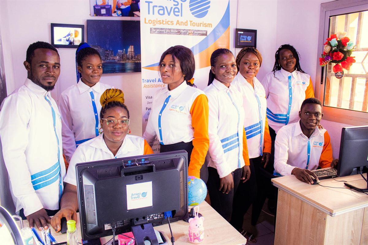 Amigo Travel advisors standing together at the office front desk