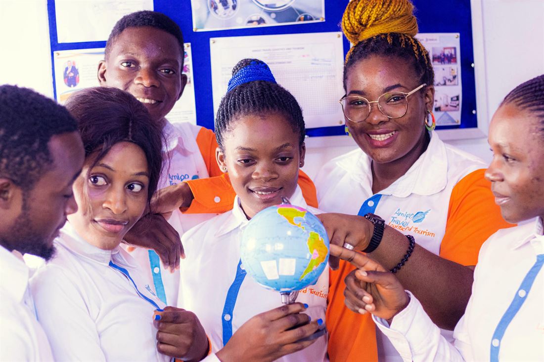 Team members planning a destination around a globe